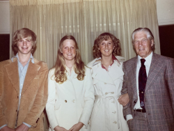 Sue Mika and her older siblings Jody and Brett standing next to George W. Romney