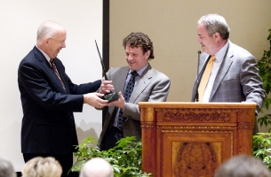 Dean Gary Cornia, left, and Ballard Center Director Todd Manwaring, right, present the Social Innovator of the Year Award to journalist and author David Bornstein. 