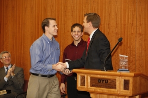 Ross Johnson and Jordan Jones accept awards from marketing professor Sterling Bone for their sale management class’s Sale Idol competition. 