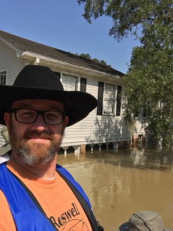 Accounting alum Jason Graham poses with his flooded house