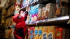 A child dressed as Spider-Man reaches for a box of cereal