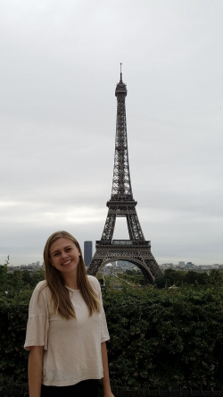 Melissa Nielsen stands in front of the Eiffel Towel in Paris