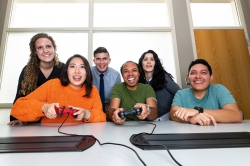 Photo illustration of co-workers playing a team video game.