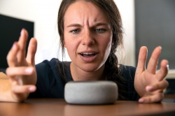 Woman yelling at smart speaker