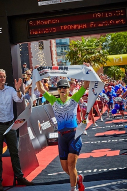 Moench crossing the finish line at the 2019 IRONMAN European Championship. Photo courtesy of James Mitchell.