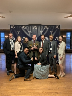 Meservy with a victorious BYU Marriott student team at the 2019 AIS conference. Photo courtesy of Tom Meservy.