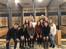 Group photo with Mary Kay Lloyd with group of BYU students standing in front of targets at at Heber Hatchets in Provo.