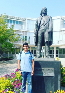 Jack Abumanneh standing in front of the Brigham Young Statue on BYU campus.