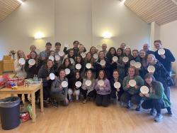 The ExDM group at the end of their trip. Students made paper plate awards to celebrate the experiences they had together. Photo courtesy of Mary Anderson.