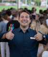 Seth Knowlton gives the camera two thumbs up and a wide smile at a MA event.
