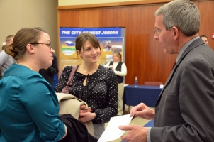 First-year MPA students Lauren Jackson and Kate Baxter discuss internship possibilities with Steve Thacker, city manager of Centerville, Utah.